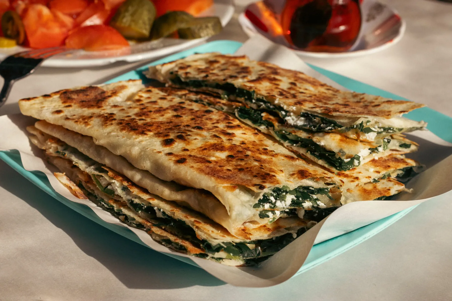 Fresh spinach and cheese gözleme cut and ready to share