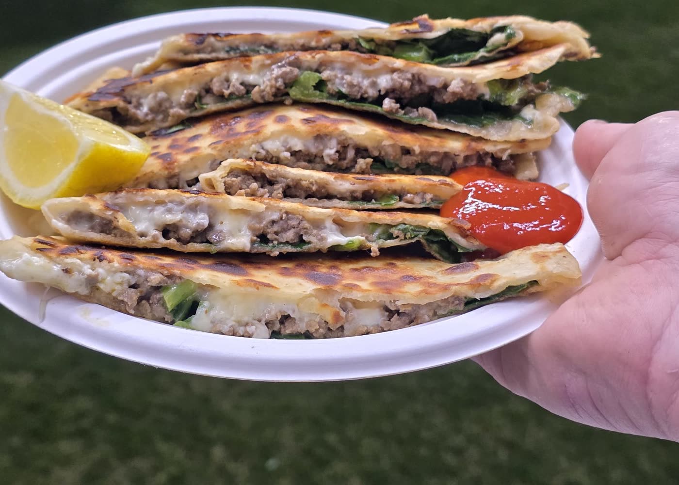 Close-up of spiced beef and spinach inside a freshly grilled gözleme