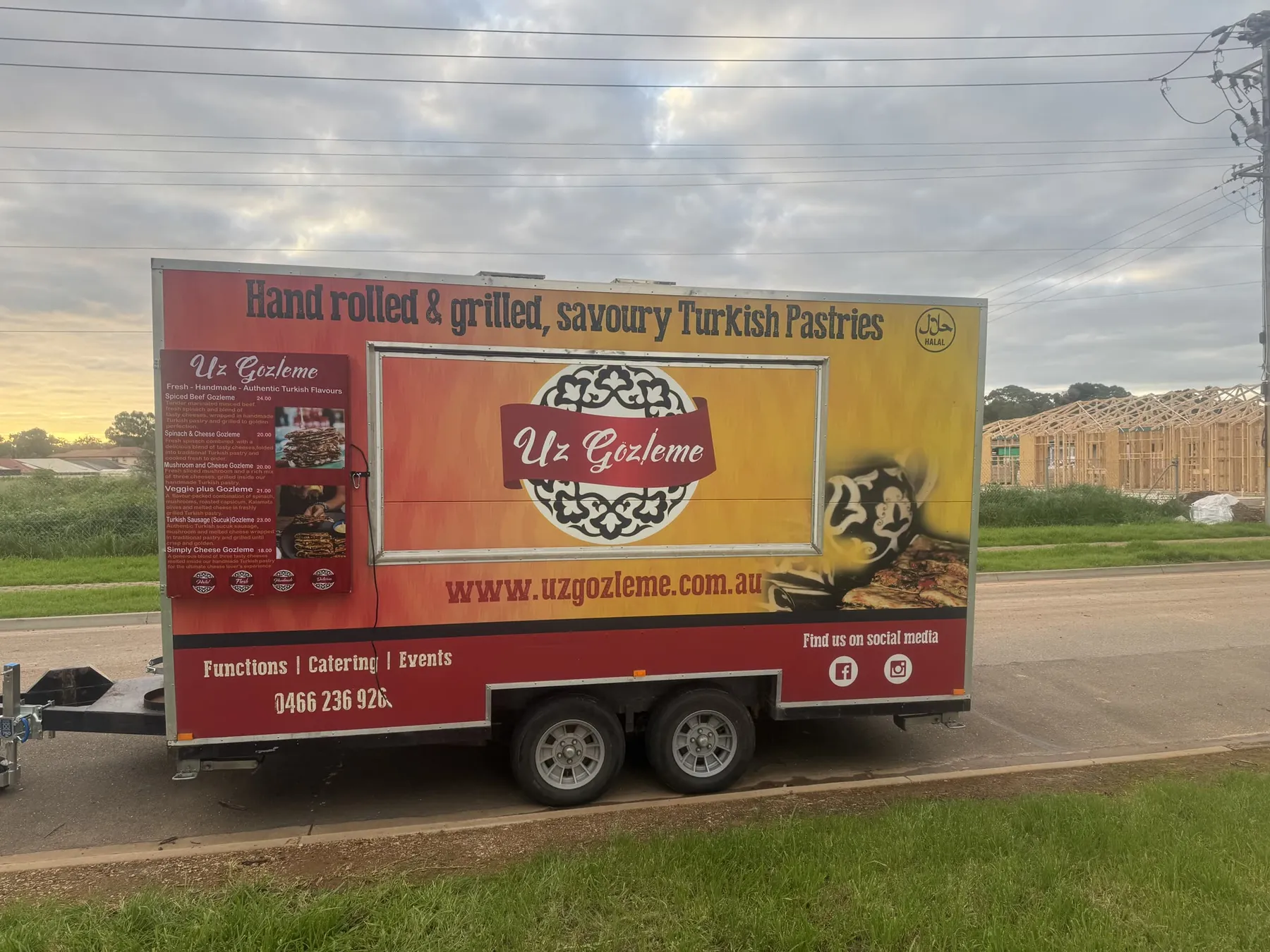 Side view of the Uz Gözleme food trailer with the full menu board